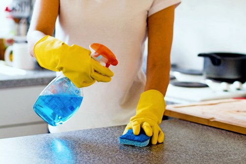 Technician wearing protective gloves and PPE during carpet cleaning
